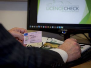 Man carrying out online licence check
